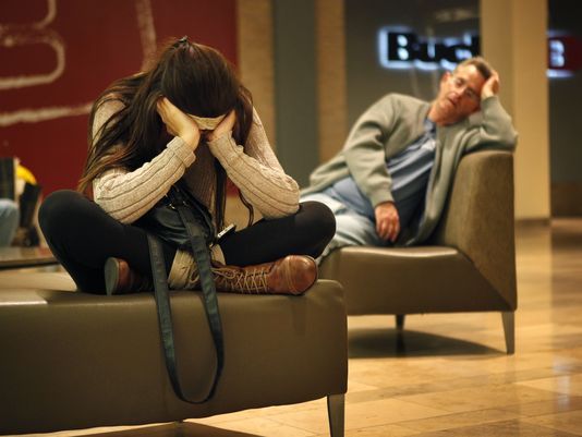 holiday shoppers rest on chairs